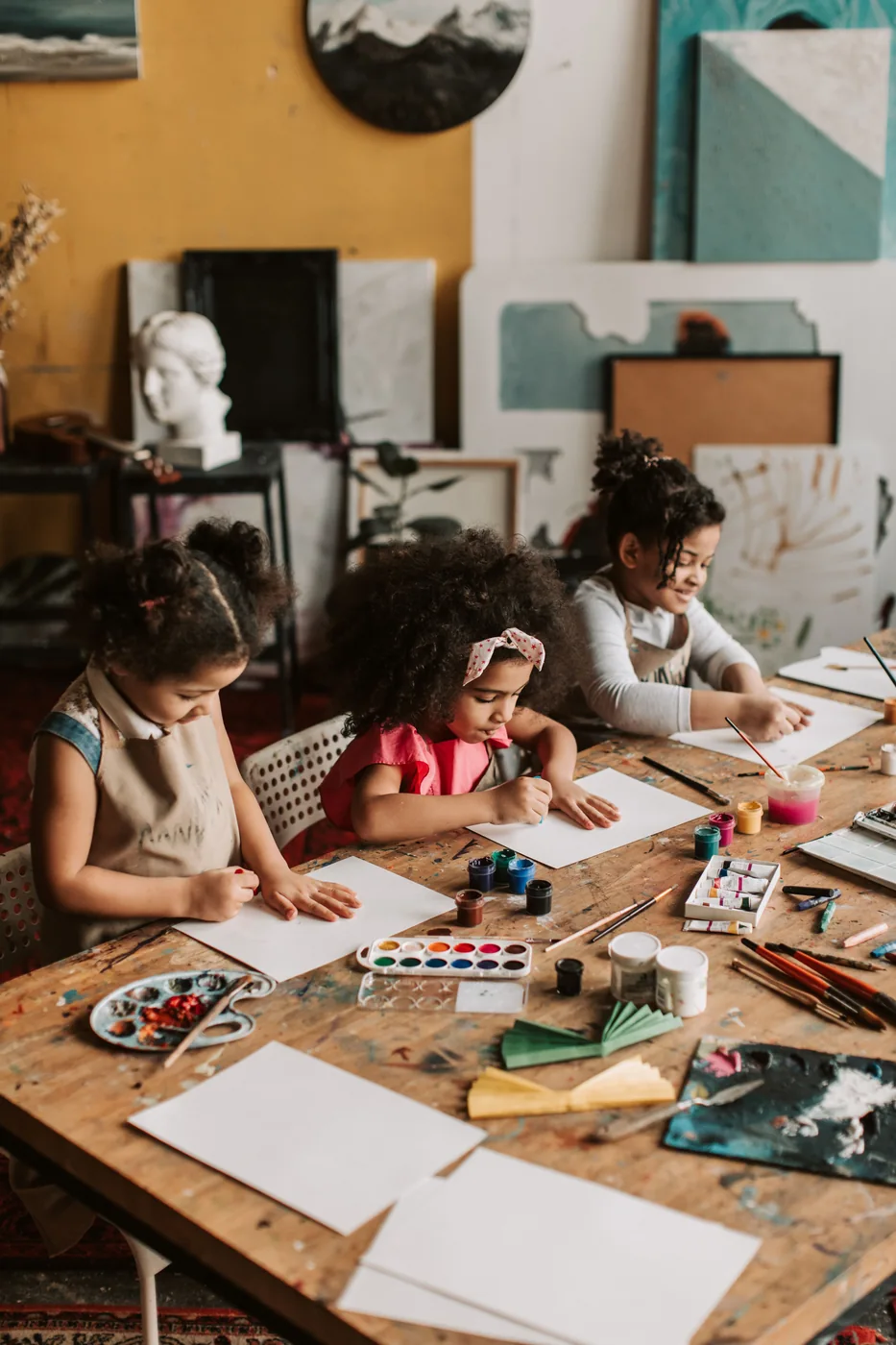 Children creating artwork in an art class