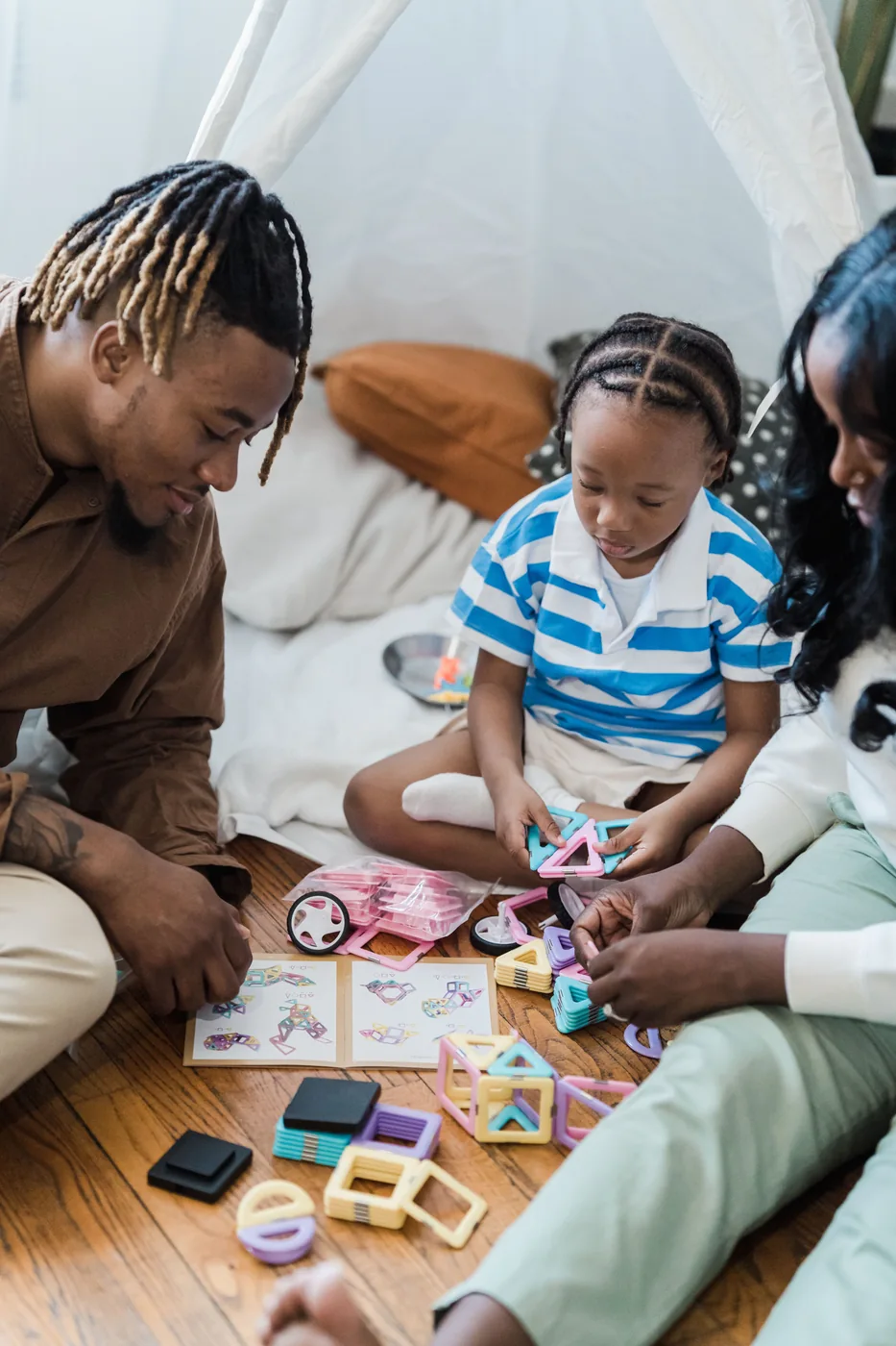 Parents and a child sharing a hands-on play activity