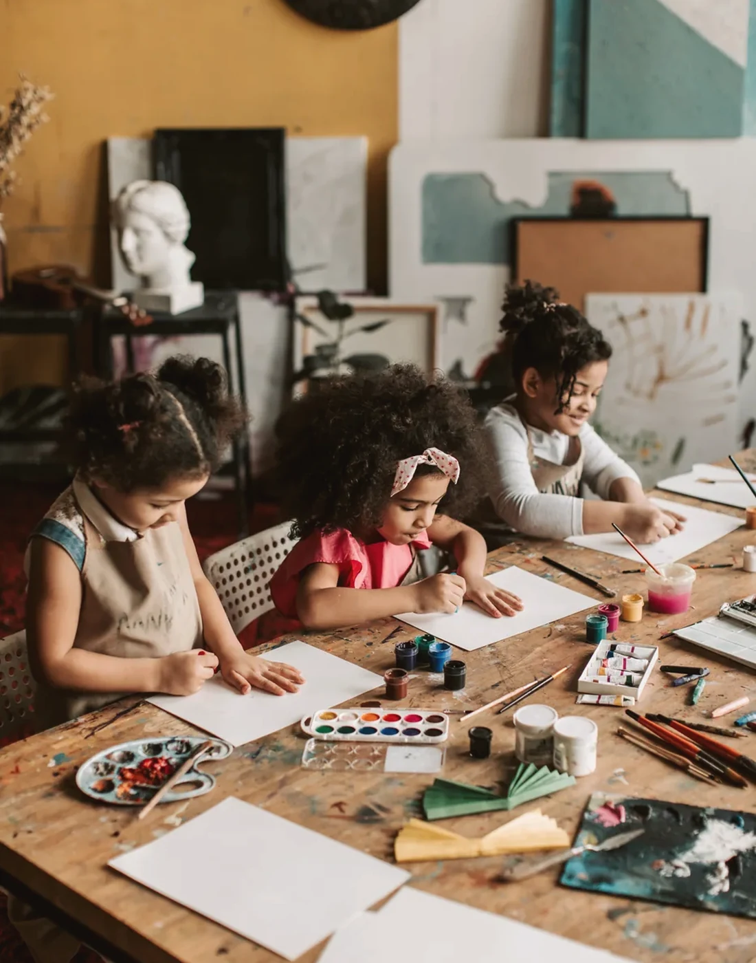 Children creating artwork during an interest-based learning activity